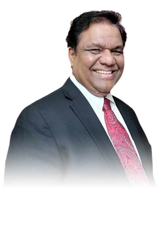 Nathan Thiyagarajah smiling in a dark suit